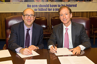 Then-Assistant Secretary Dr. David Michaels, USDOL-OSHA and Lee Styslinger, III, Chief Executive Officer, Altec Industries at the alliance renewal ceremony on December 1, 2015.