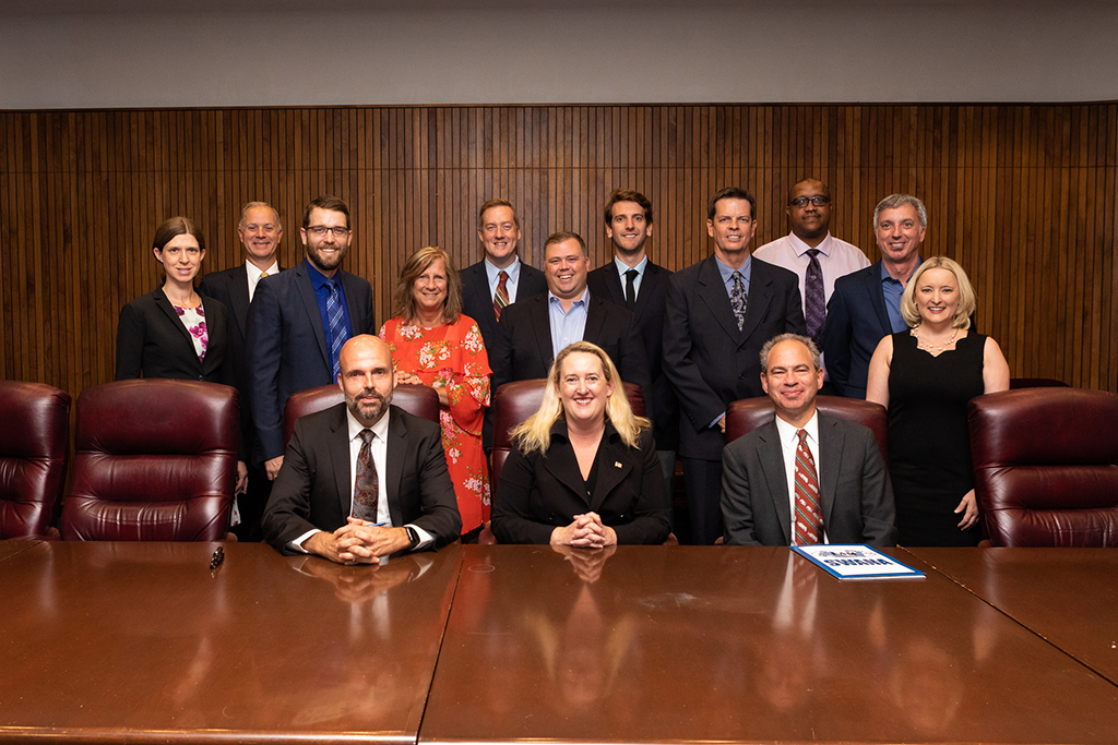 Principal Deputy Assistant Secretary Loren Sweatt, USDOL-OSHA (seated, center), with representatives of NWRA, SWANA, and OSHA at the Alliance signing ceremony on September 27, 2019.