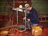Figure 2: Shipyard Competent Person testing a confined space before cold work begins