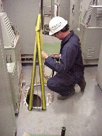 Figure 9: Marine Chemist testing confined space prior to entry