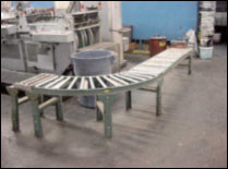 Figure 26. Use a conveyor system to move product to the palletizing position.