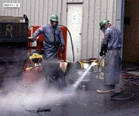 Figure 14: Workers using pressure washing with face protection