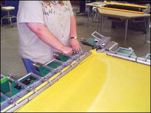 Figure 5. Table level at proper height for this employee to exert force on clamps without stressful bending.