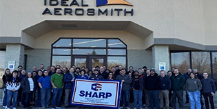 Ideal Aerosmith Employees stand with SHARP flag