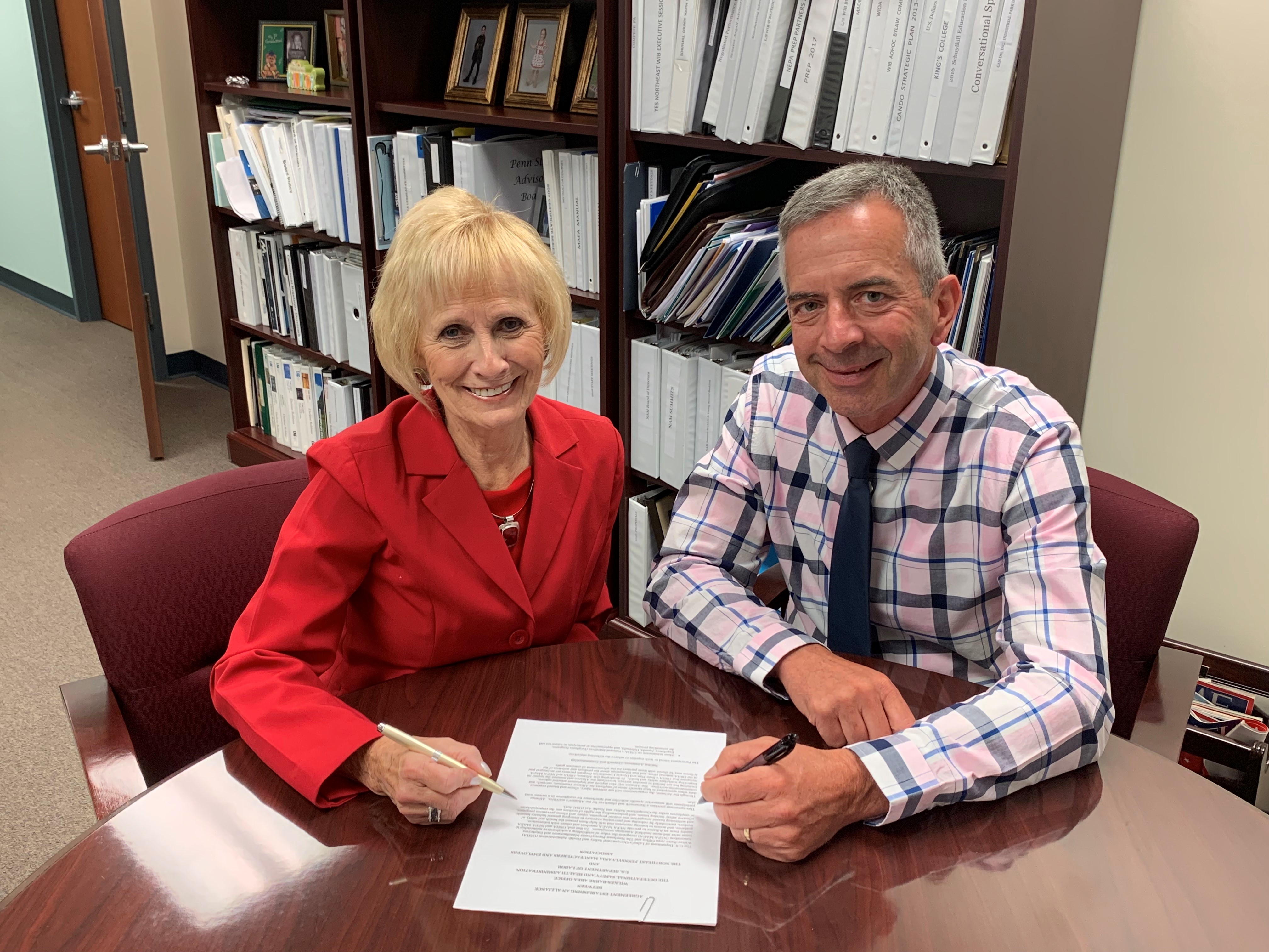 Mark Stelmack, Area Director, DOL-OSHA Wilkes-Barre Area Office and Darlene Robbins, President, NPMEA sign the alliance agreement on August 15, 2019