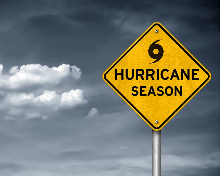 Yellow street sign reading "Hurricane Season"