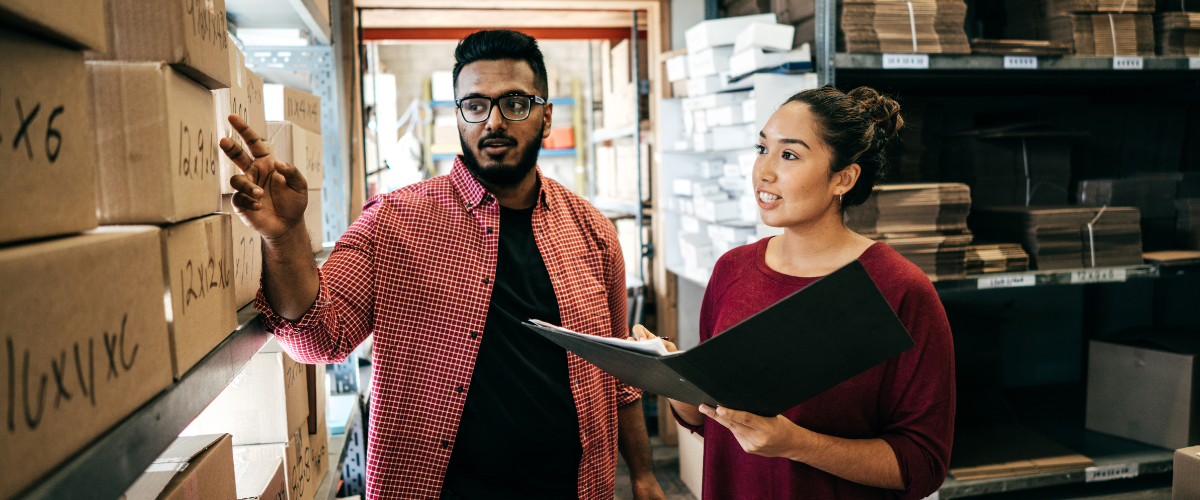 A man and a woman taking inventory at a small business