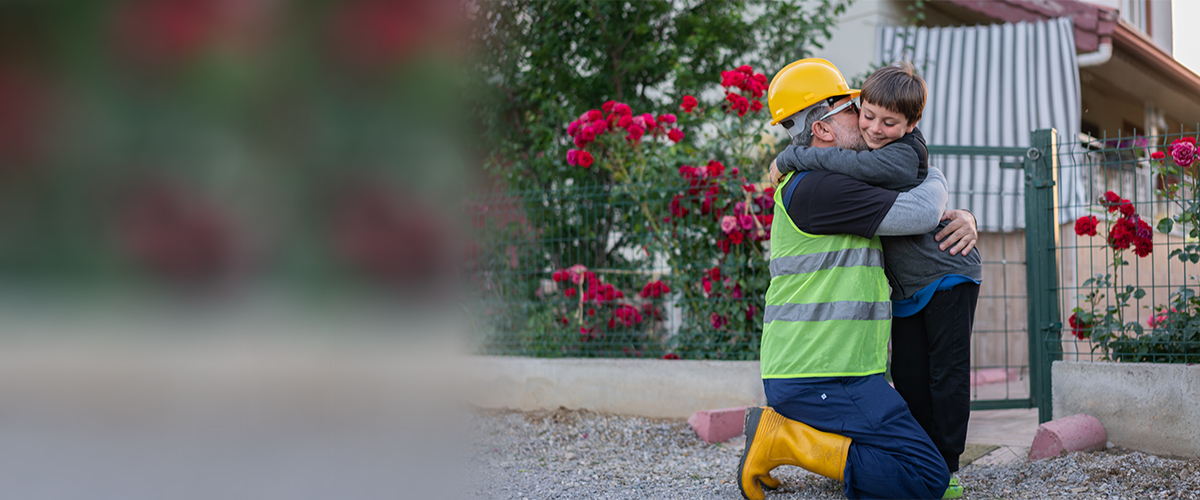 A construction worker says goodbye to his child at the entrance of their house | iStock: 1405274099 | Photo credit: mgstudyo