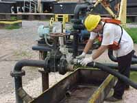 Figure 24: Worker hooking up suction hose.