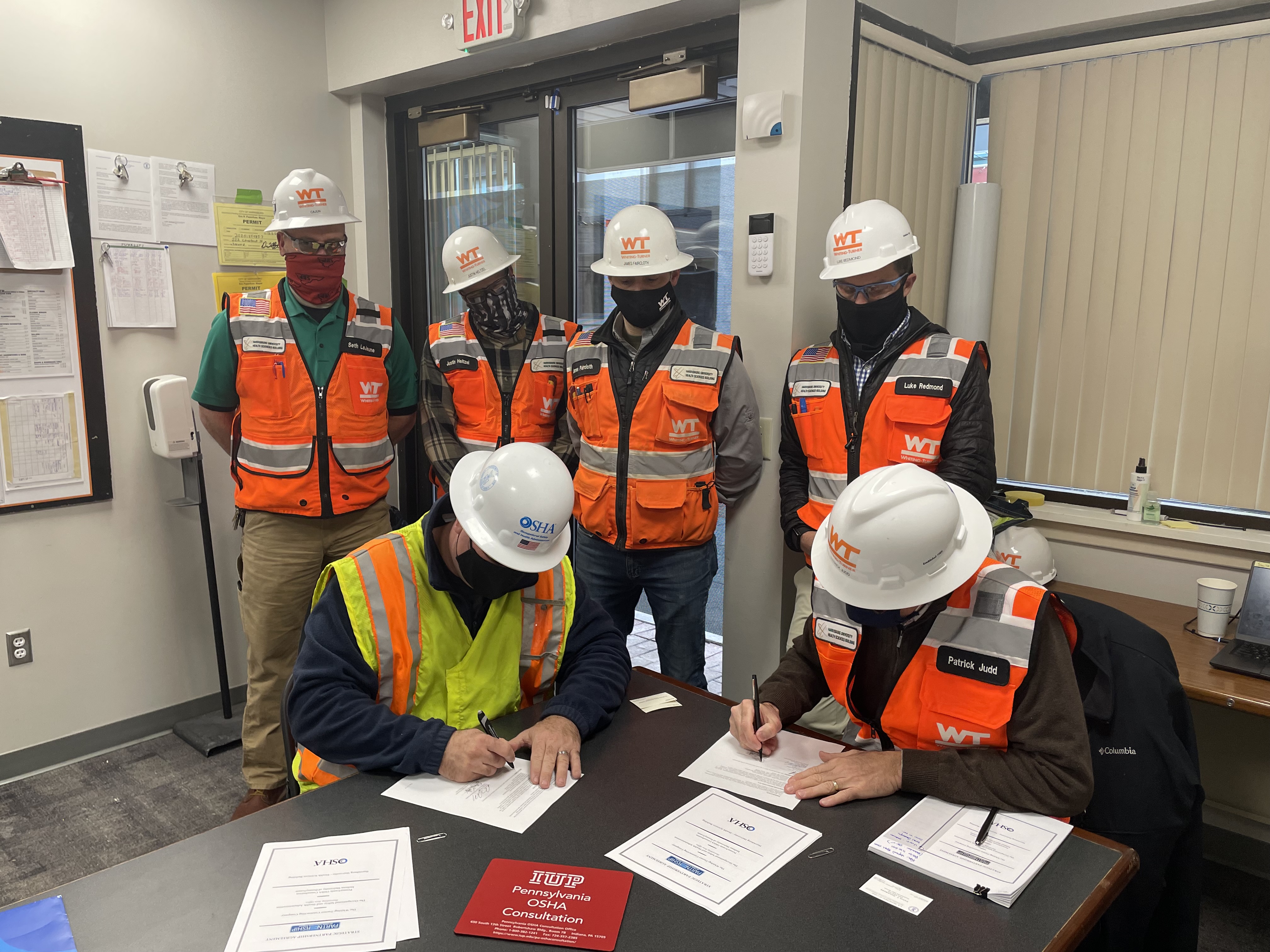 OSHA and Whiting Turner Contracting Company representatives sign the Partnership agreement on December 16, 2021.