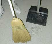 Worker sweeping broken glass