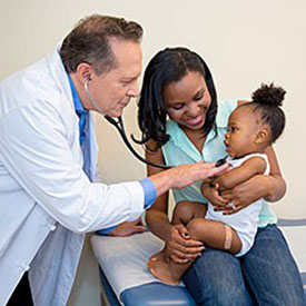 A doctor doing a checkup on a child | Photo Credit: Centers for Disease Control and Prevention
