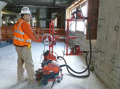 Contractors adopt innovative concrete drill jig to reduce silica exposures during concrete drilling operations. | Source:  UC Ergonomic Research and Graduate Training Program