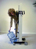 Fig. 9: wheel machine to bottle storage area and tilt bottle onto cradle