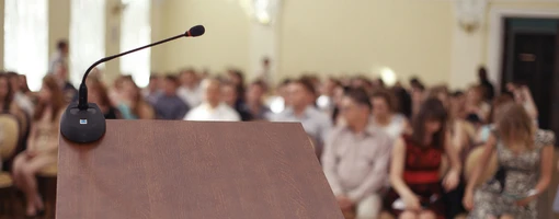 Lectern with a microphone in front of an audience