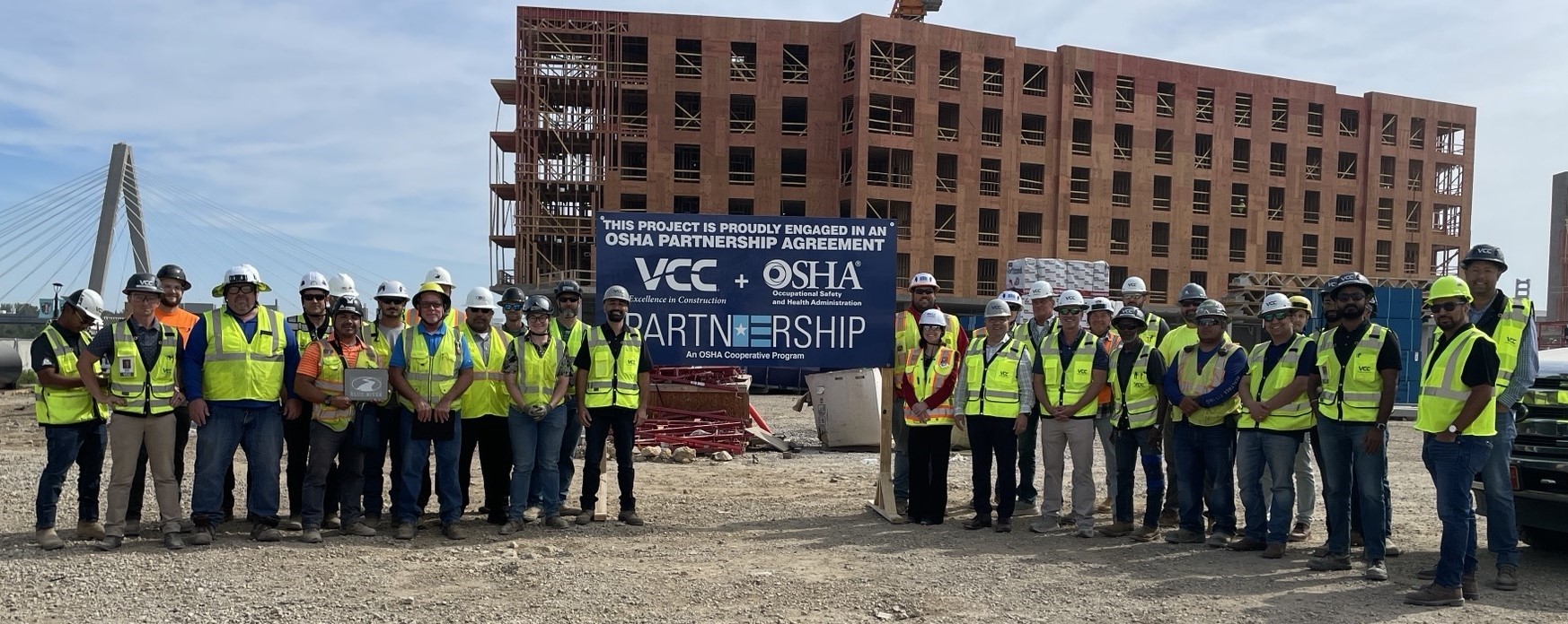 Attendees to the Partnership signing ceremony pose for a group photo, after the agreement was signed.