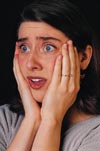 Person holding their head in their hands