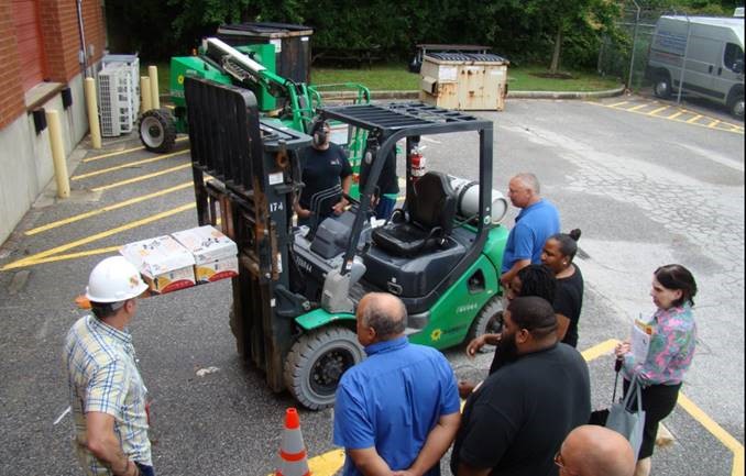 Participants learning interviewing techniques from a MOSH safety consultant during a breakout session. In this session, participants conducted mock interviews of forklift operators.