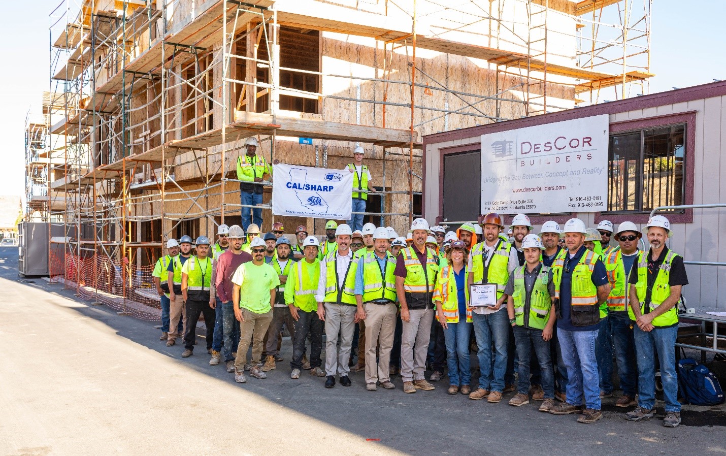 DesCor Builders receiving their SHARP certificate and flag.