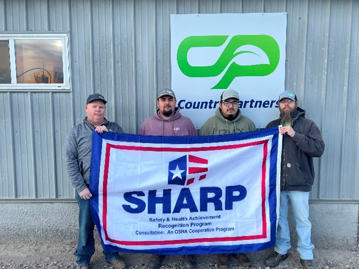 Country Partners Cooperative (CPC) management and employees with the SHARP flag
