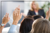 people raising hands during training