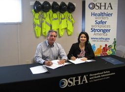 Lee Lewis, chief executive officer with Lee Lewis Construction Co., signs OSHA alliance agreement with Elizabeth L. Routh, OSHA's area director in Lubbock, Texas. Lee Lewis, chief executive officer with Lee Lewis Construction Co., signs OSHA alliance agreement with Elizabeth L. Routh, OSHA's area director in Lubbock, Texas.