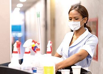 Cleaning staff worker wearing a face covering