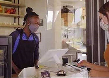 Retail worker wearing face covering