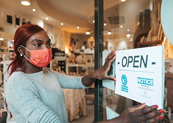 Worker placing signage on a door