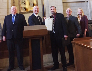 Nebraska Governor Pete Ricketts (second from left) displays his Grain Safety Stand-Up Proclamation with representatives from OSHA, the National Safety Council, and the Nebraska Grain and Feed Association.