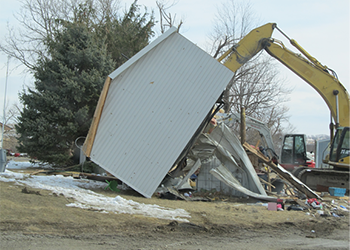 Work crew clearing garage blowd from its foundation after tornado