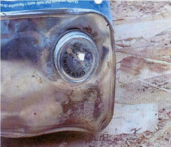 Photo #1: Hole punched into the cap of the can to pour flammable liquid. Photo #1: Hole punched into the cap of the can to pour flammable liquid.