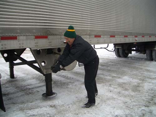 Figure 1 - Manual Cranking to lower the Trailer Landing Gear. Photo Credit: Women In Trucking, Inc. Figure 1 - Manual Cranking to lower the Trailer Landing Gear. Photo Credit: Women In Trucking, Inc.